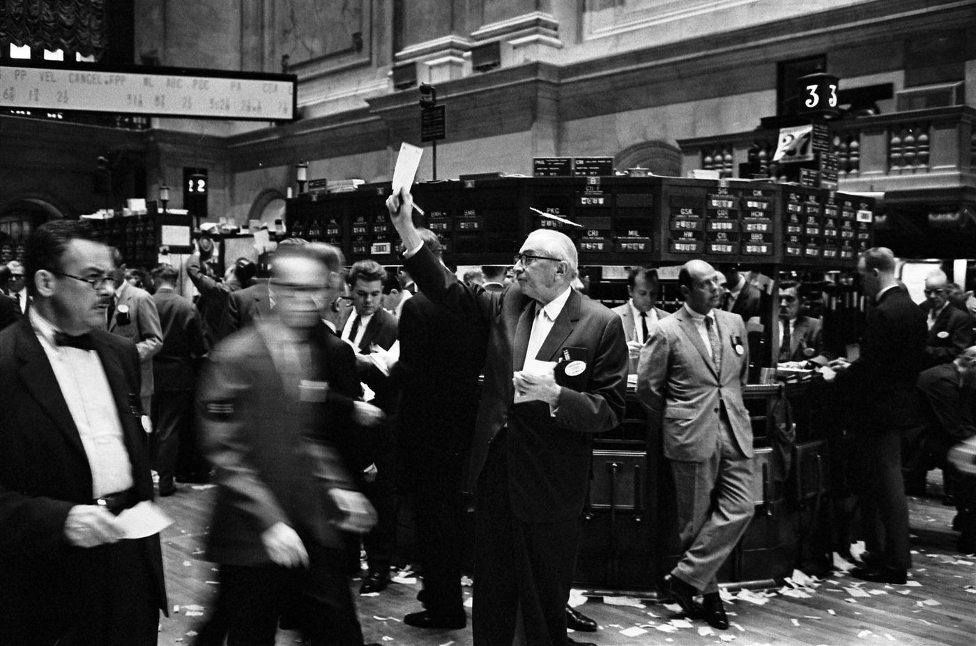 Floor traders working the New York Stock Exchange, a scene that had changed remarkably little by the time it absorbed the news of the Exxon-Mobil deal in December 1998